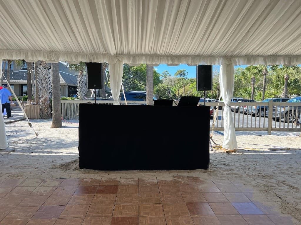 Anchor Entertainment DJ booth under a draped beach tent with JBL speakers on Hilton Head Island