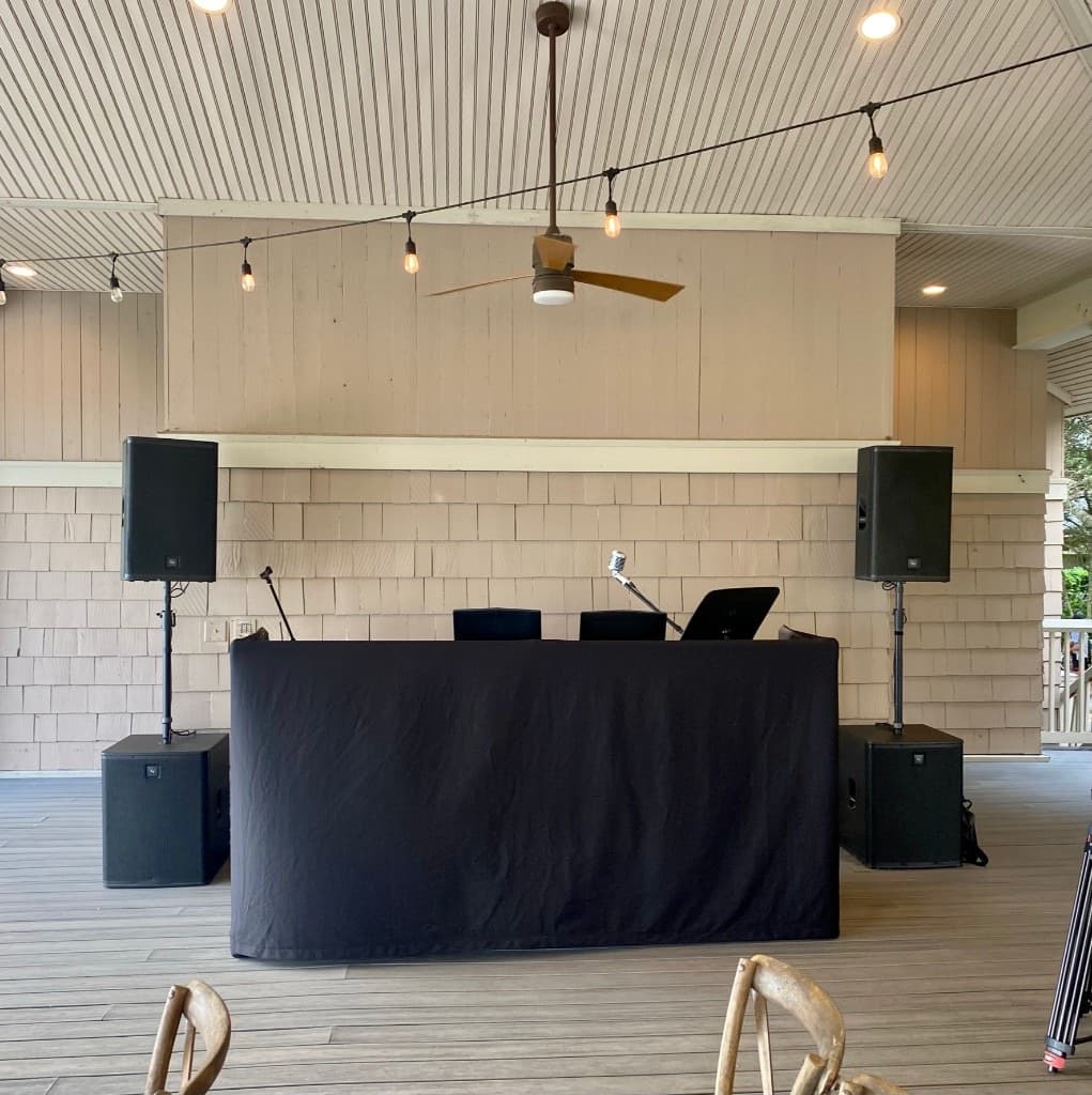 Anchor Entertainment JBL speakers and subs on a covered pavilion with whitewashed shingle walls