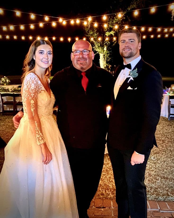 Gary Lucca celebrating with a bride and groom at a Lowcountry reception